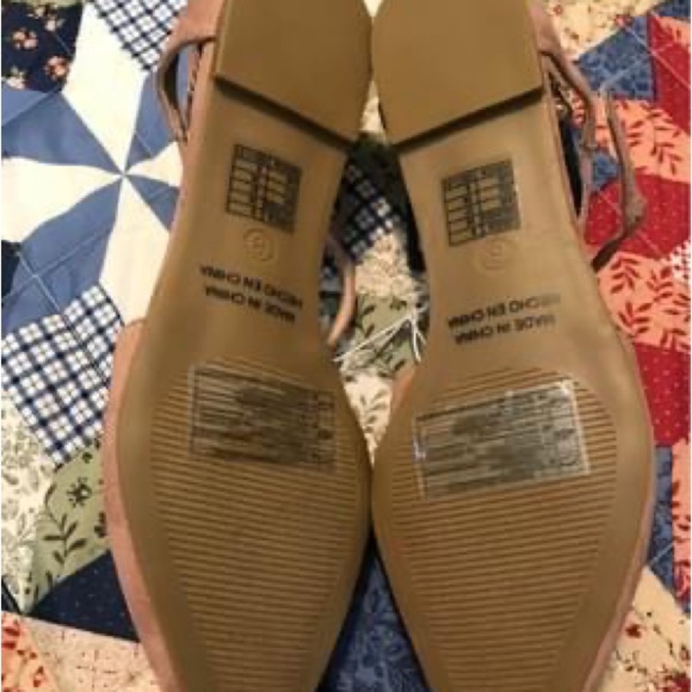 Nude flats with crossover strap style.